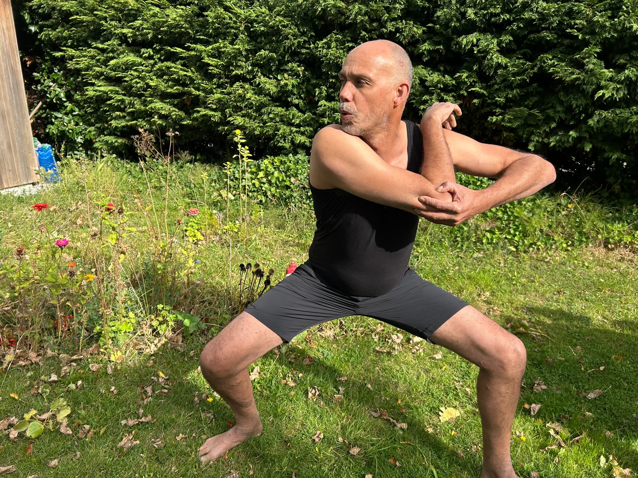Rene in a wide, strong stance mid maneuver