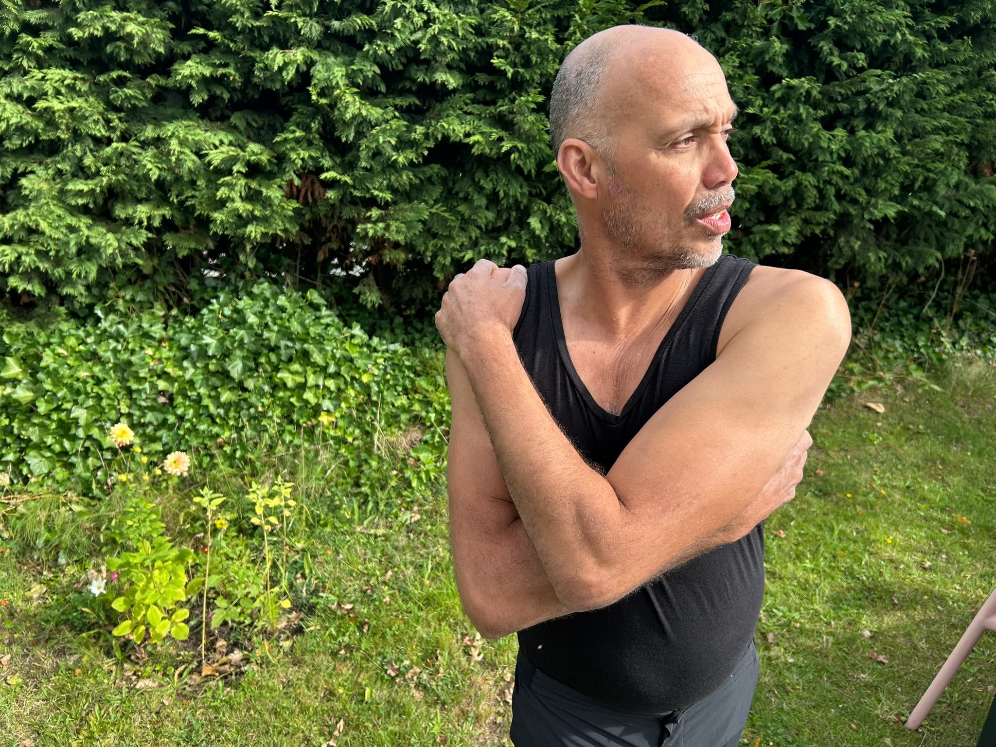 Rene holding his own shoulder, working into a restriction